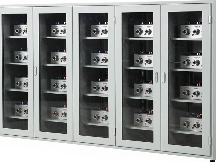 Modular lithium battery rack cabinet with visible terminal interfaces, high-key studio lighting, neutral clean backgroun